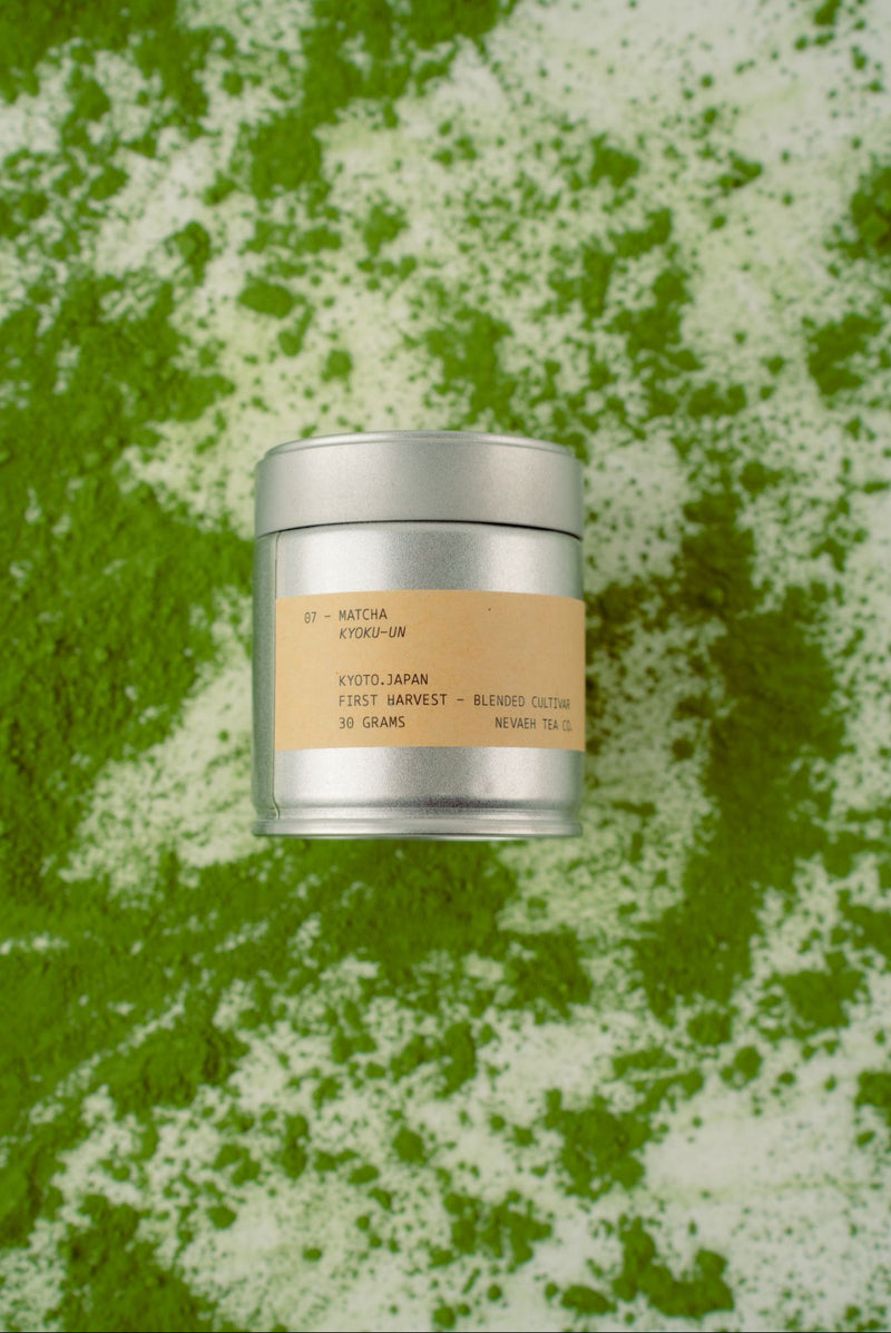 Silver cylindrical container with a beige label on a green textured background