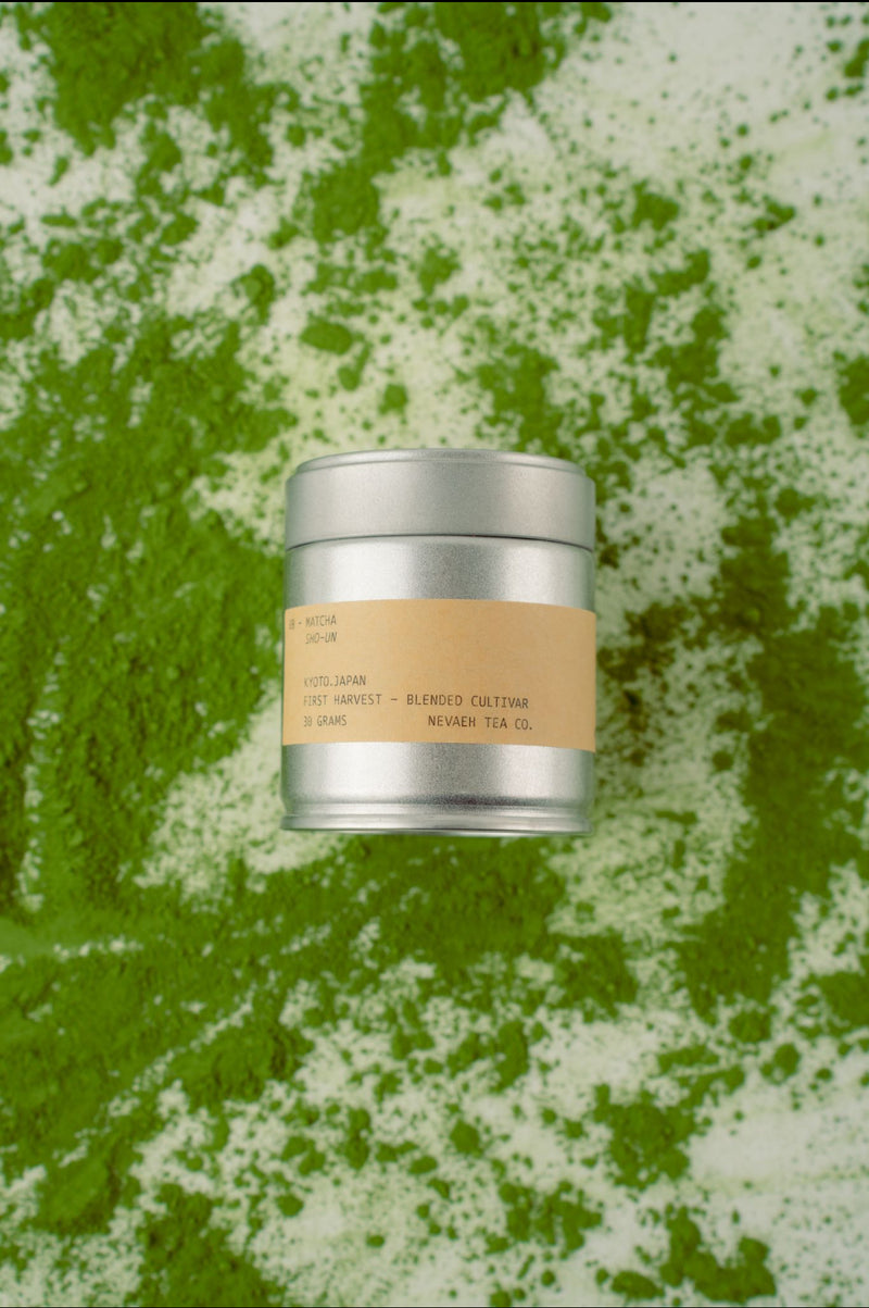 Silver cylindrical container with a brown label on a green and white textured background