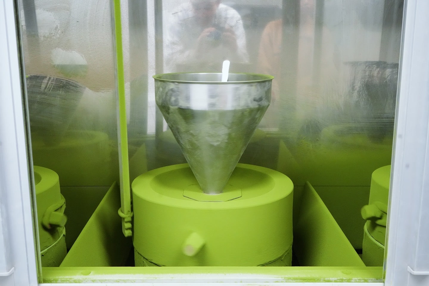 Green machine with a funnel-like component inside a transparent enclosure