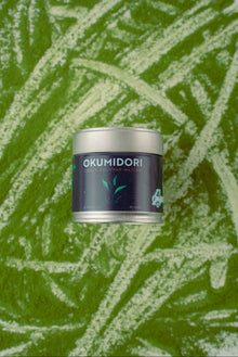 Okumidori product container on a green leafy background
